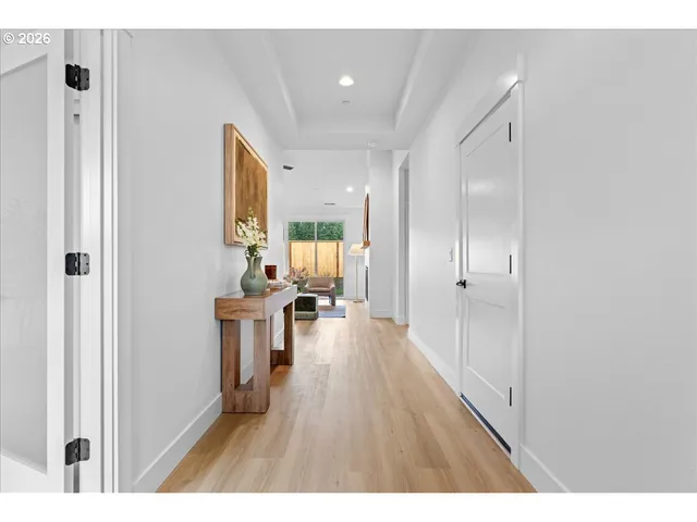 a open kitchen with white cabinets and wooden floor