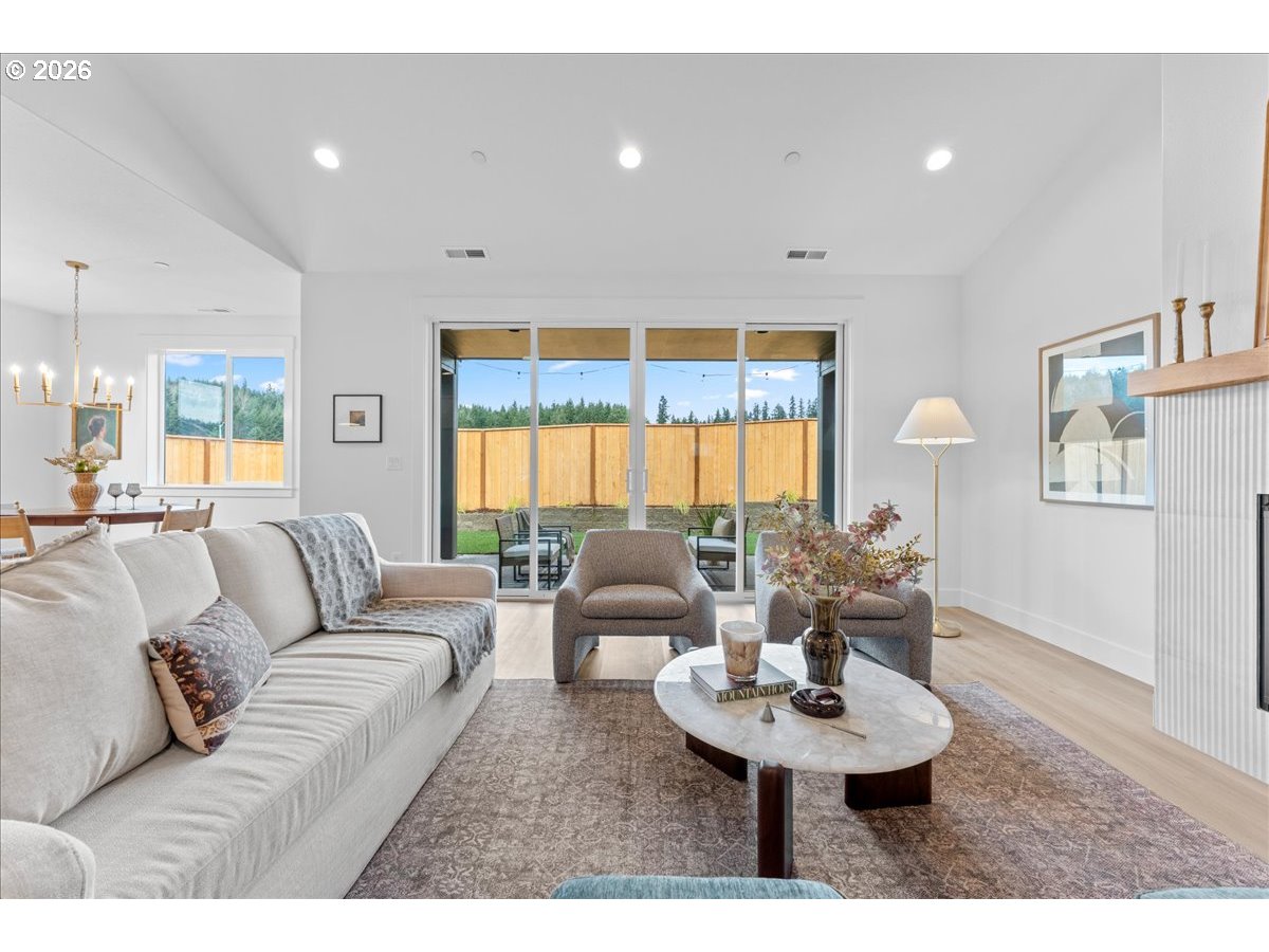 789 Riley Drive Northeast Silverton, OR 97381 - Photo 3 of 24 a living room with furniture a large window and a chandelier