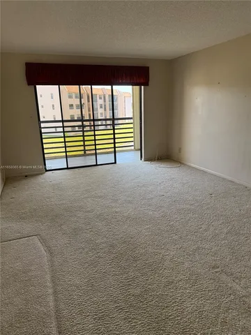 a view of a livingroom with a ceiling fan and window