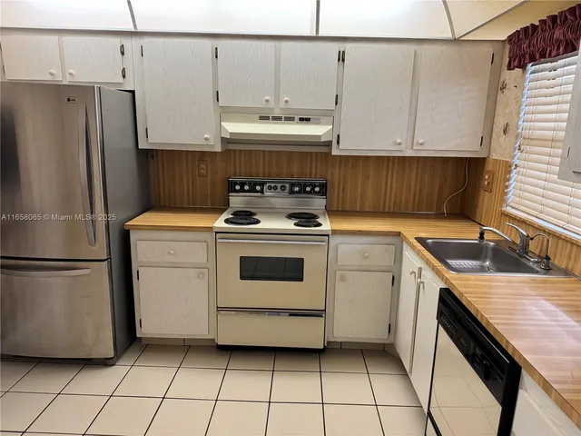 a kitchen with a stove a sink and a refrigerator
