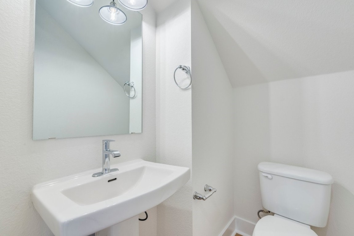 2600 Gattis School Road, Unit 101 Round Rock, TX 78664 - Photo 13 of 23 a bathroom with a toilet sink and mirror