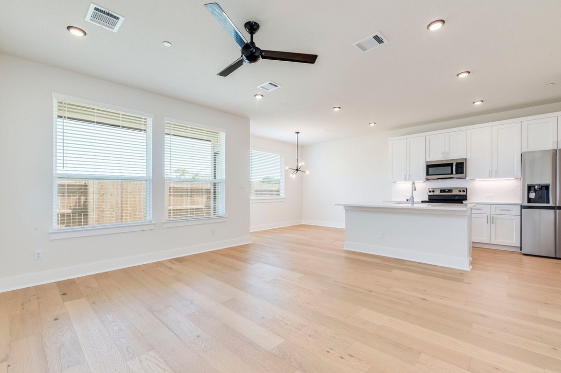 2600 Gattis School Road, Unit 101 Round Rock, TX 78664 - Photo 4 of 23 a view of kitchen with stainless steel appliances refrigerator oven microwave and cabinets