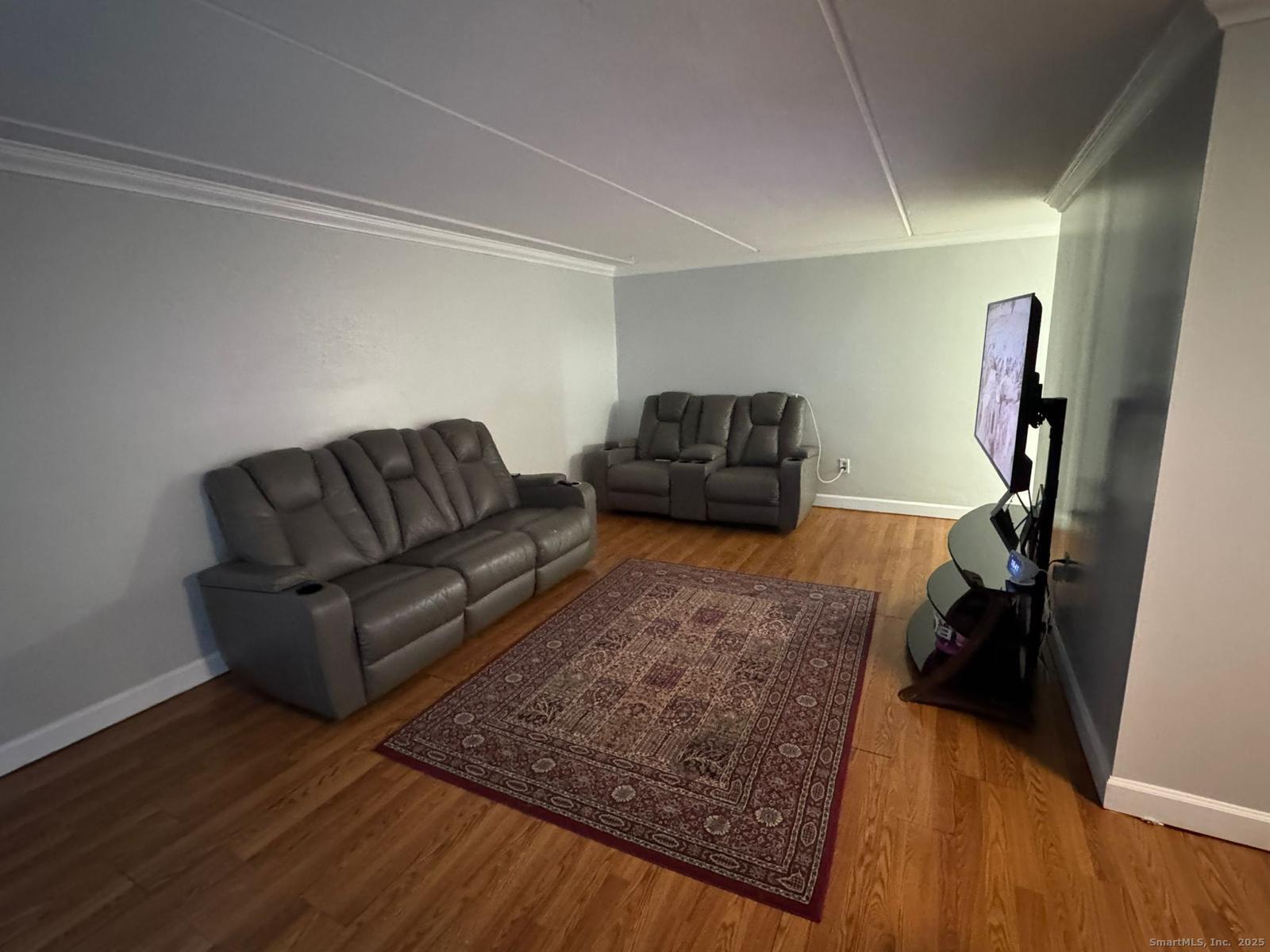 126 Triangle Street, Unit B13 Danbury, CT 06810 - Photo 12 of 29 a living room with furniture and a couch