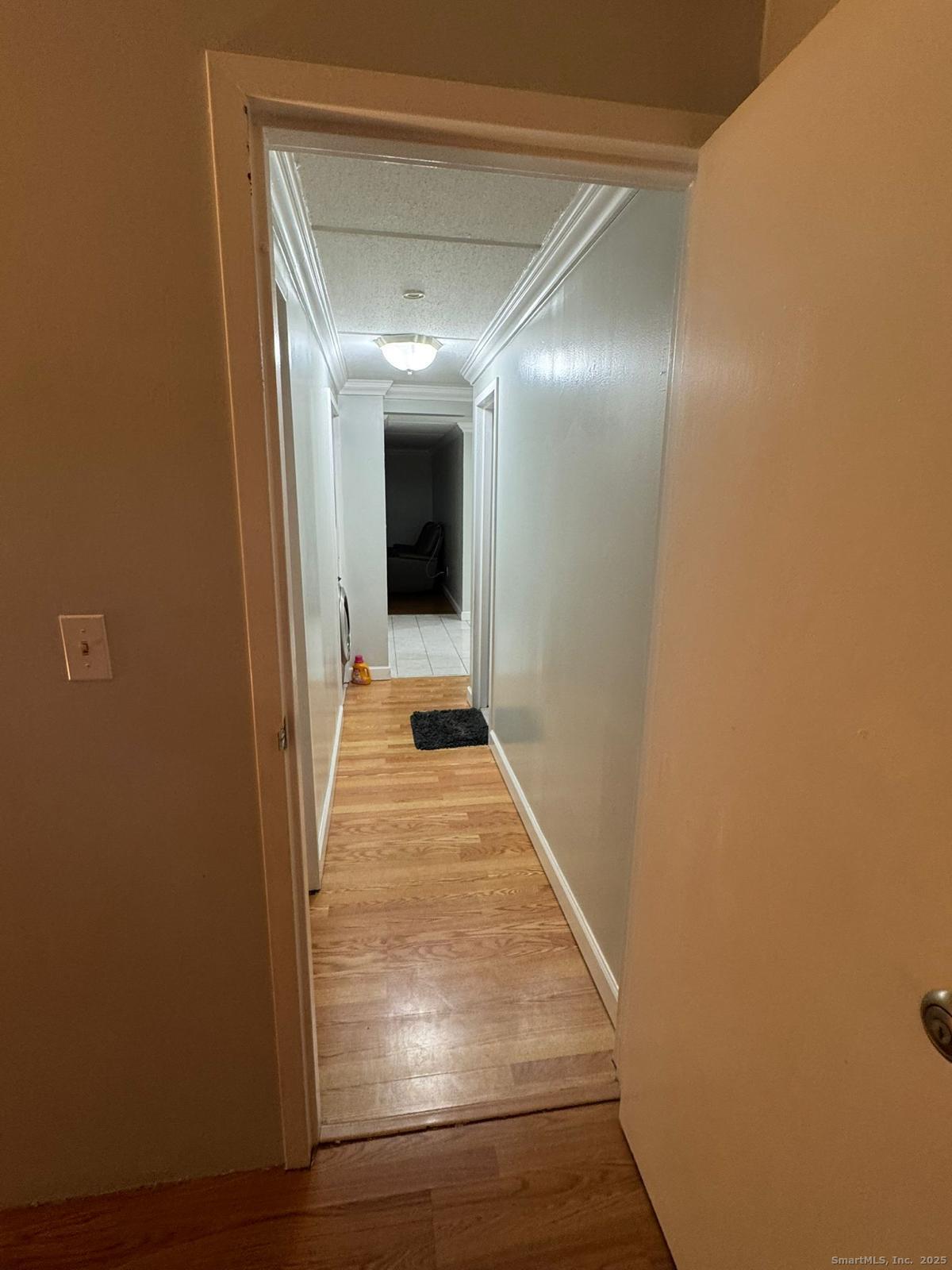 126 Triangle Street, Unit B13 Danbury, CT 06810 - Photo 15 of 29 a view of a hallway with wooden floor and staircase