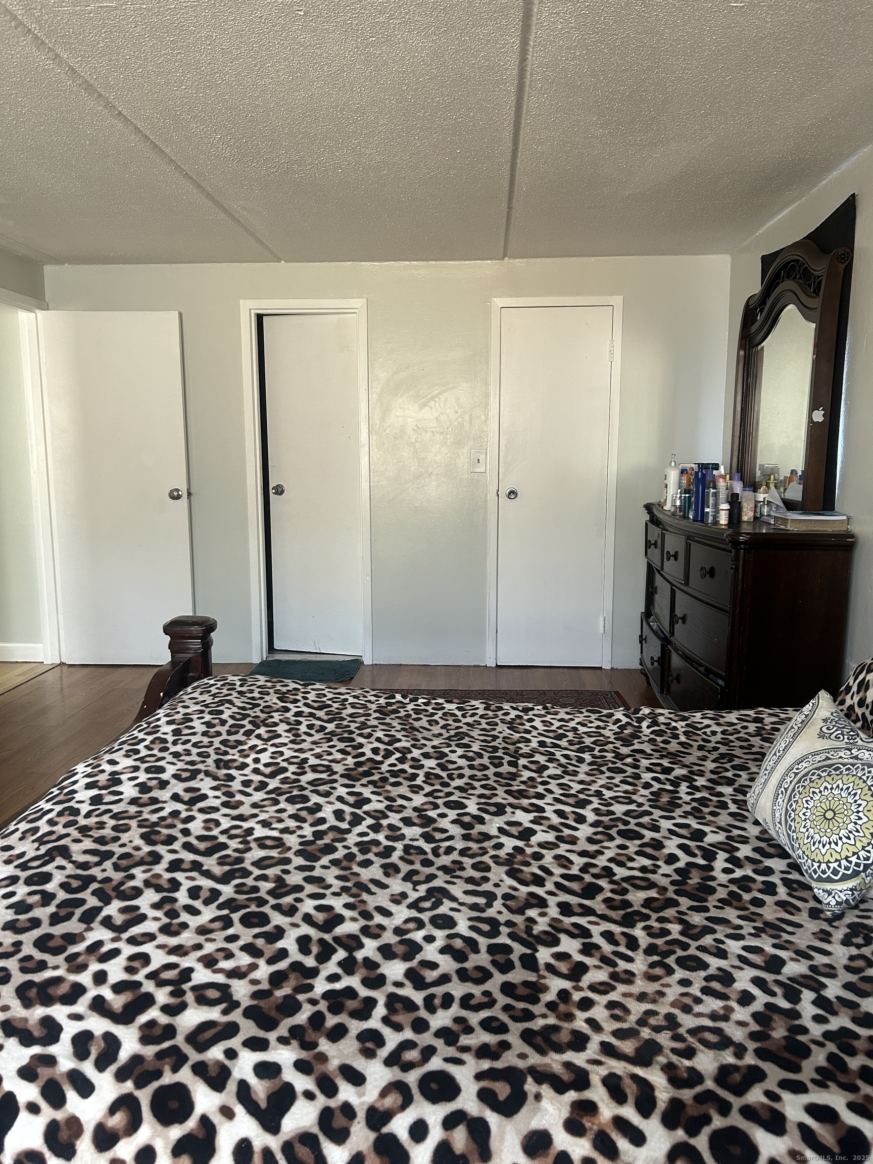 126 Triangle Street, Unit B13 Danbury, CT 06810 - Photo 18 of 29 a bedroom with a bed and wooden floor