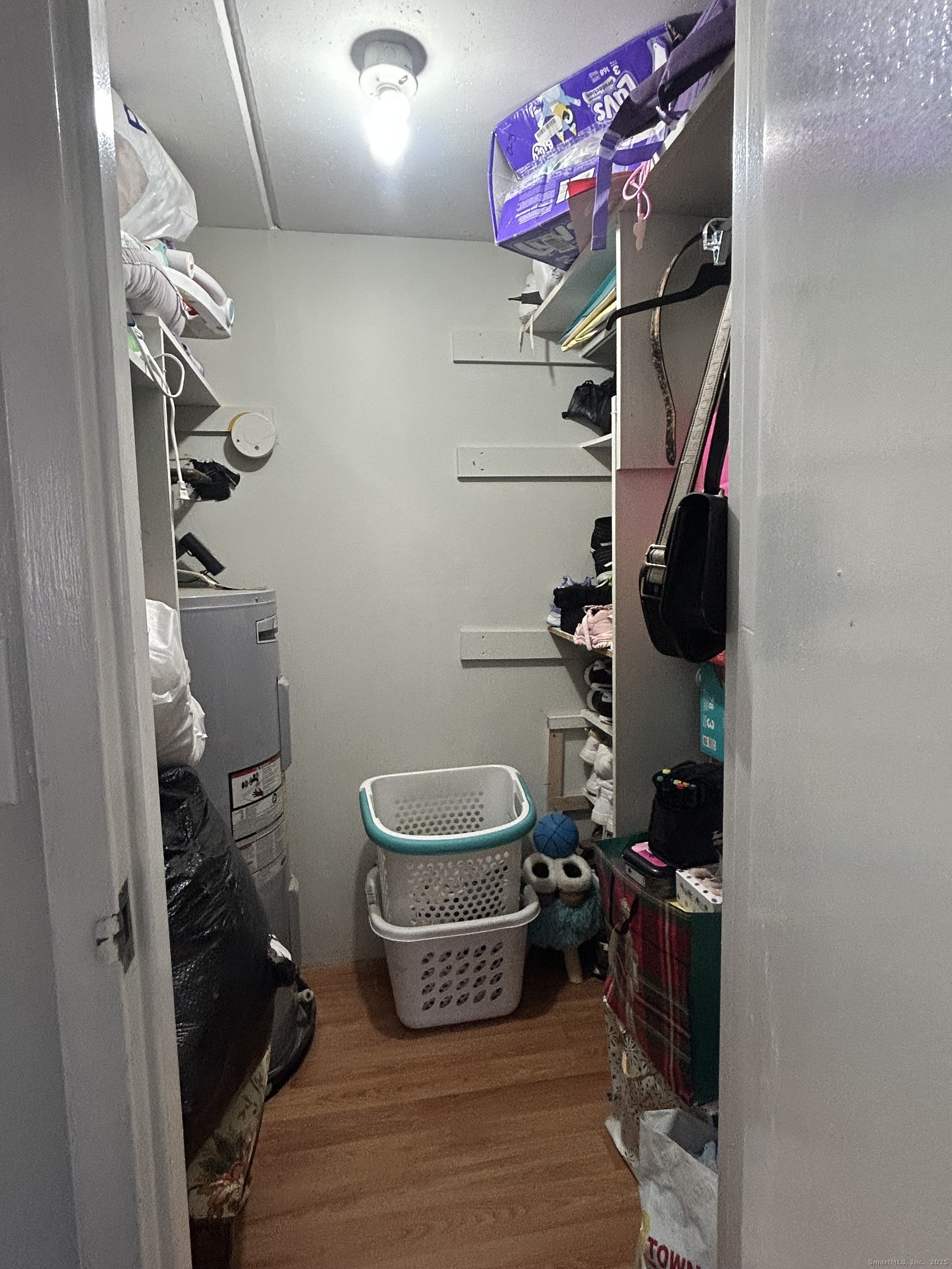 126 Triangle Street, Unit B13 Danbury, CT 06810 - Photo 20 of 29 a view of walk in closet with clothes and shoes