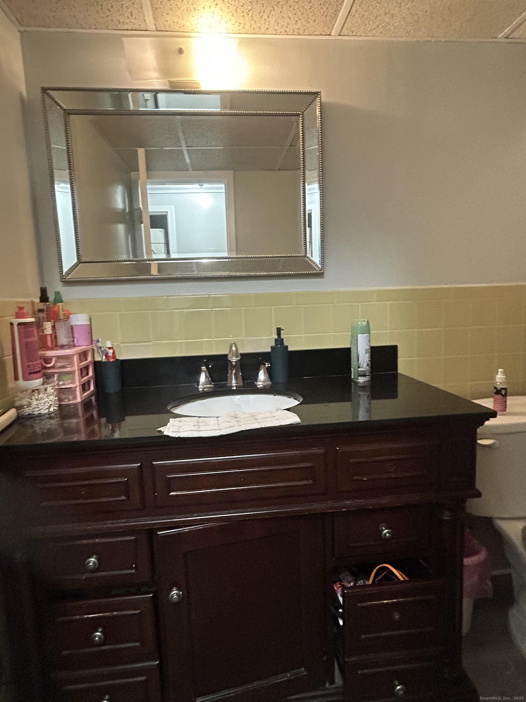 126 Triangle Street, Unit B13 Danbury, CT 06810 - Photo 21 of 29 a bathroom with a sink and a mirror