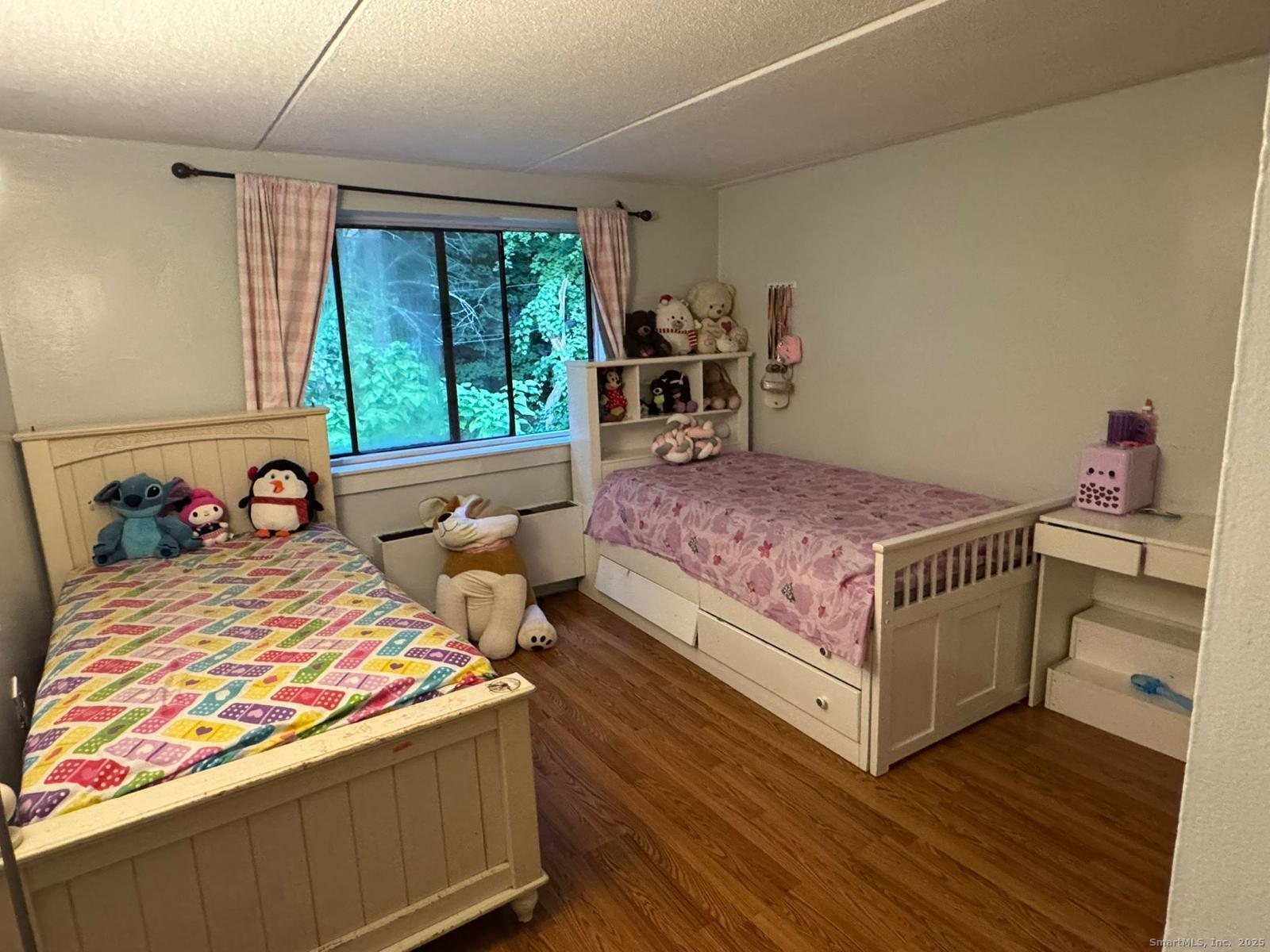 126 Triangle Street, Unit B13 Danbury, CT 06810 - Photo 24 of 29 a bedroom with a bed and a window