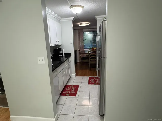 a kitchen with granite countertop white cabinets and sink