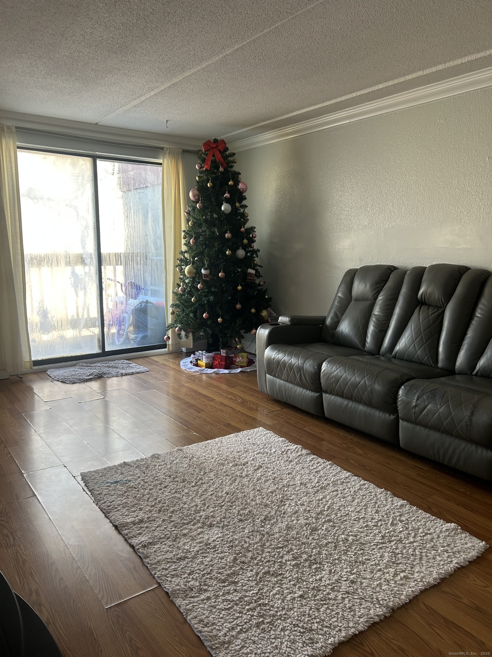 126 Triangle Street, Unit B13 Danbury, CT 06810 - Photo 9 of 29 a living room with furniture and a large window