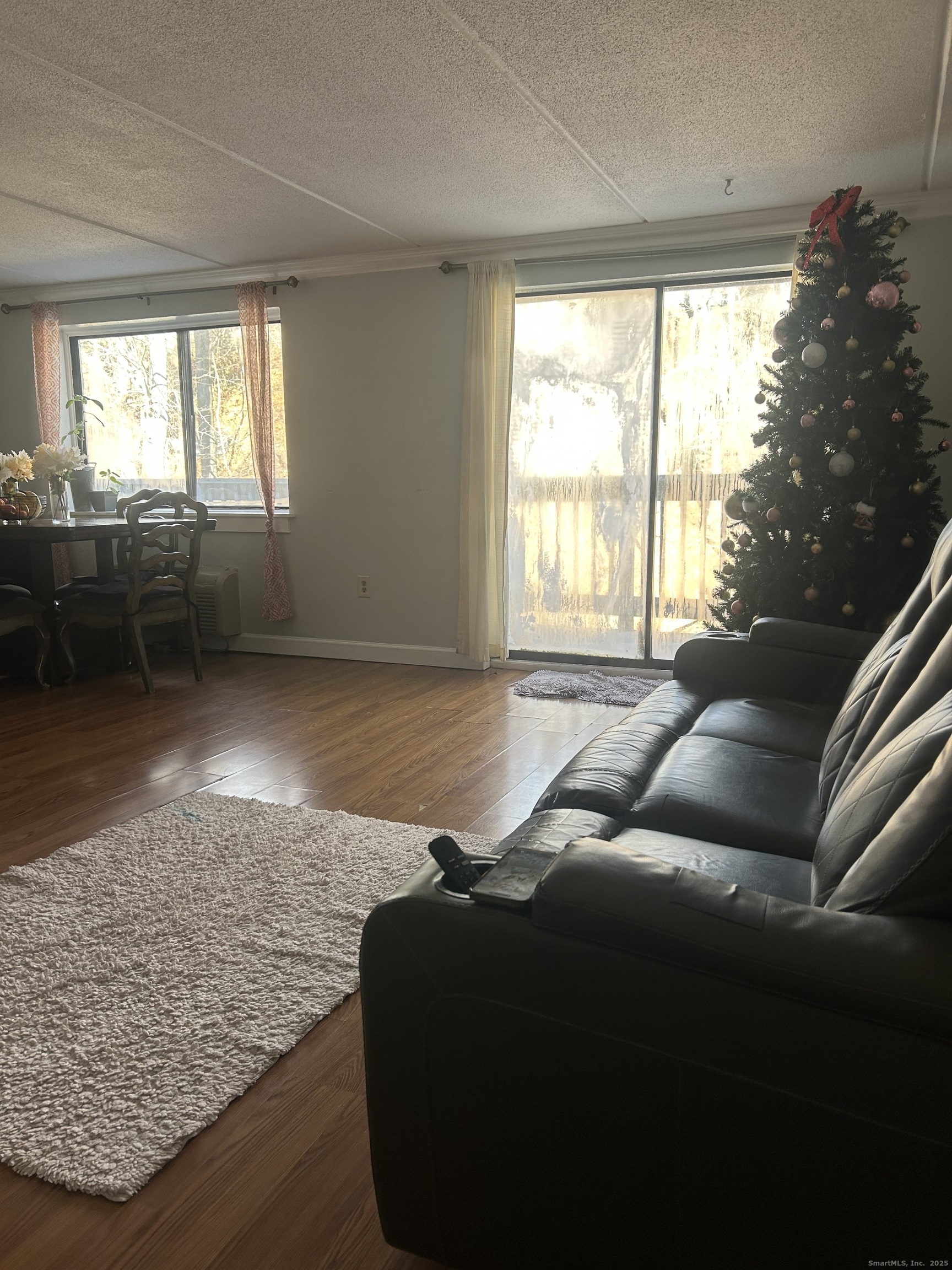 126 Triangle Street, Unit B13 Danbury, CT 06810 - Photo 10 of 29 a living room with furniture and a floor to ceiling window