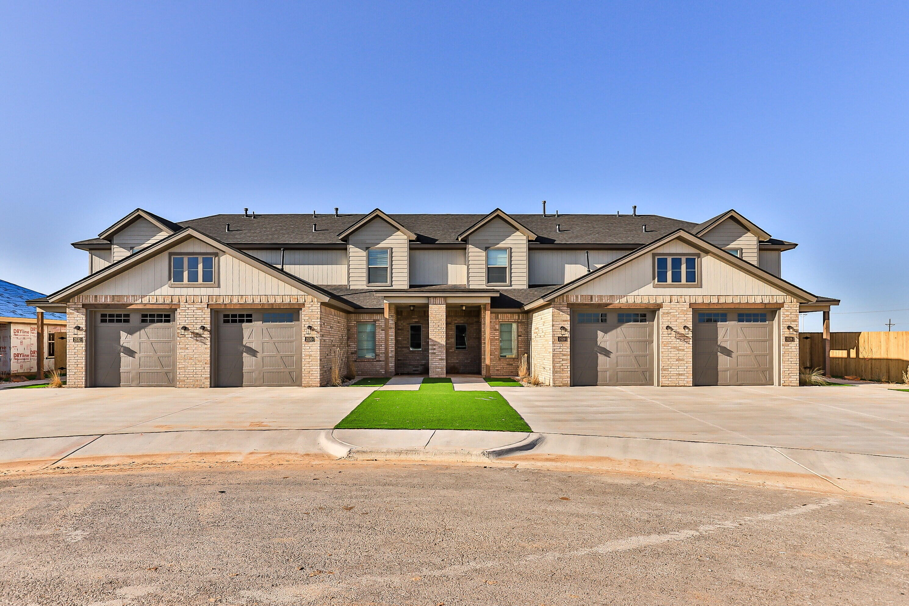 2526 138th Street Lubbock, TX 79423 - Photo 1 of 36 a front view of a house with a yard and potted plants