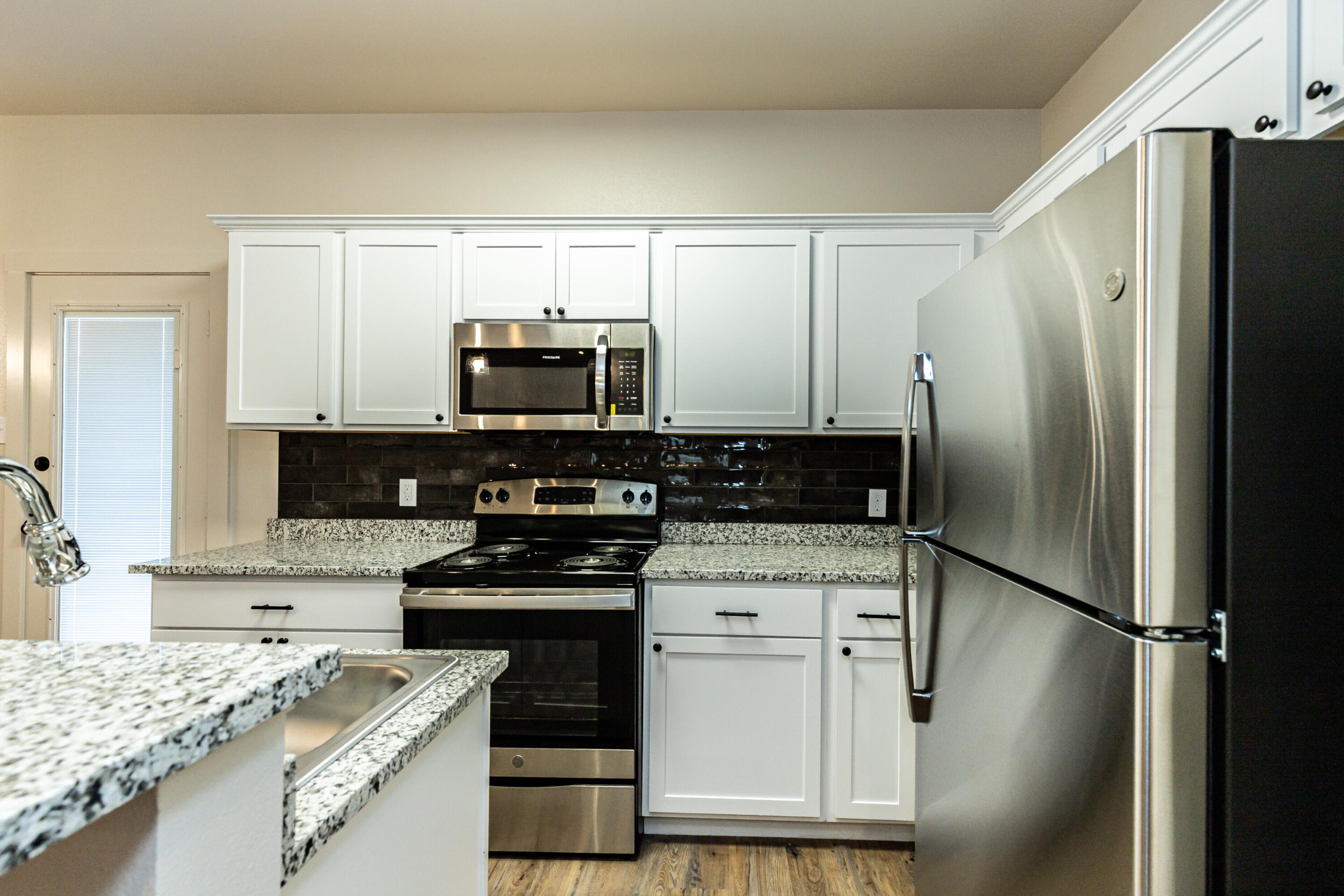 2526 138th Street Lubbock, TX 79423 - Photo 17 of 36 a kitchen with a refrigerator stove and sink