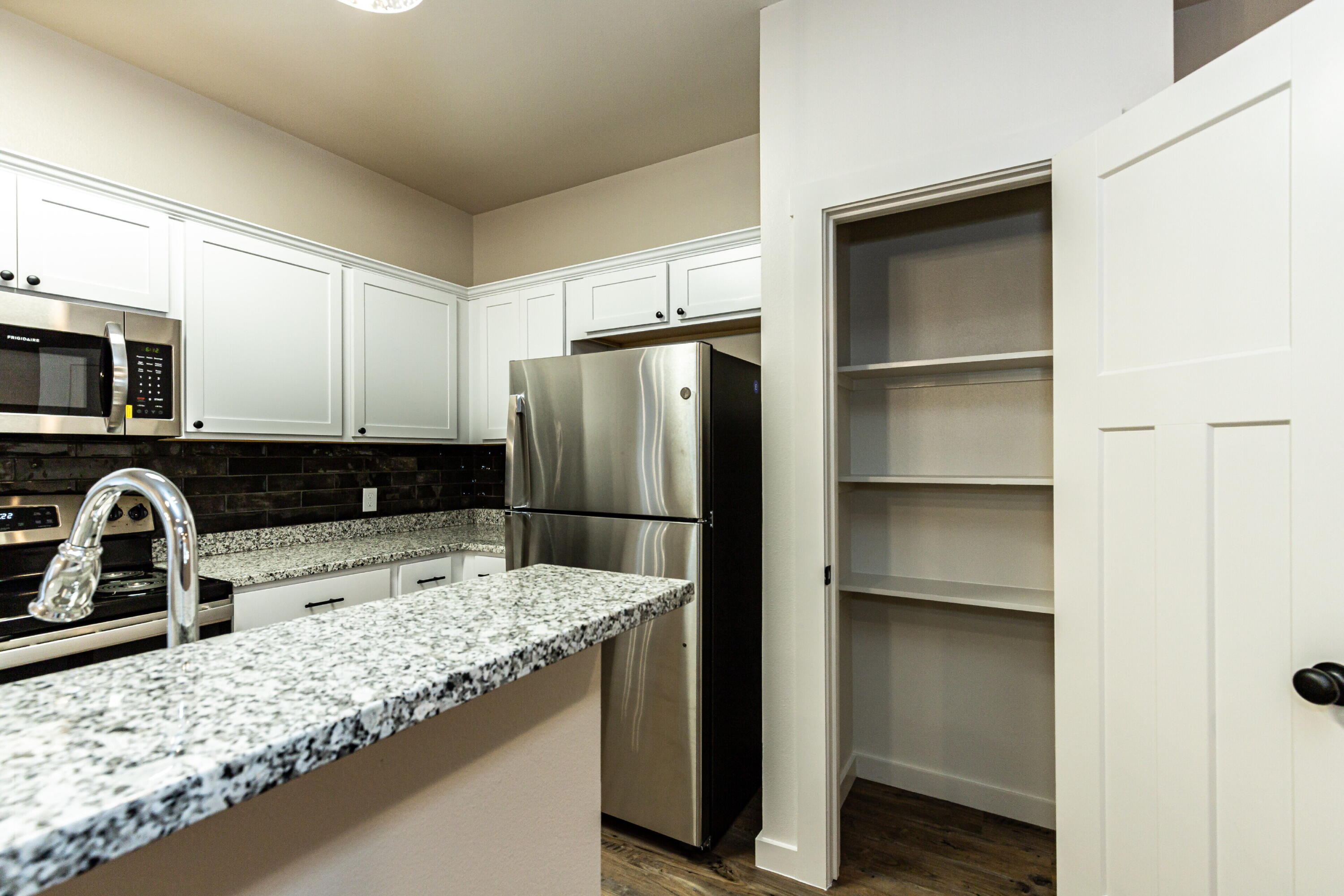 2526 138th Street Lubbock, TX 79423 - Photo 18 of 36 a kitchen with a refrigerator and a sink