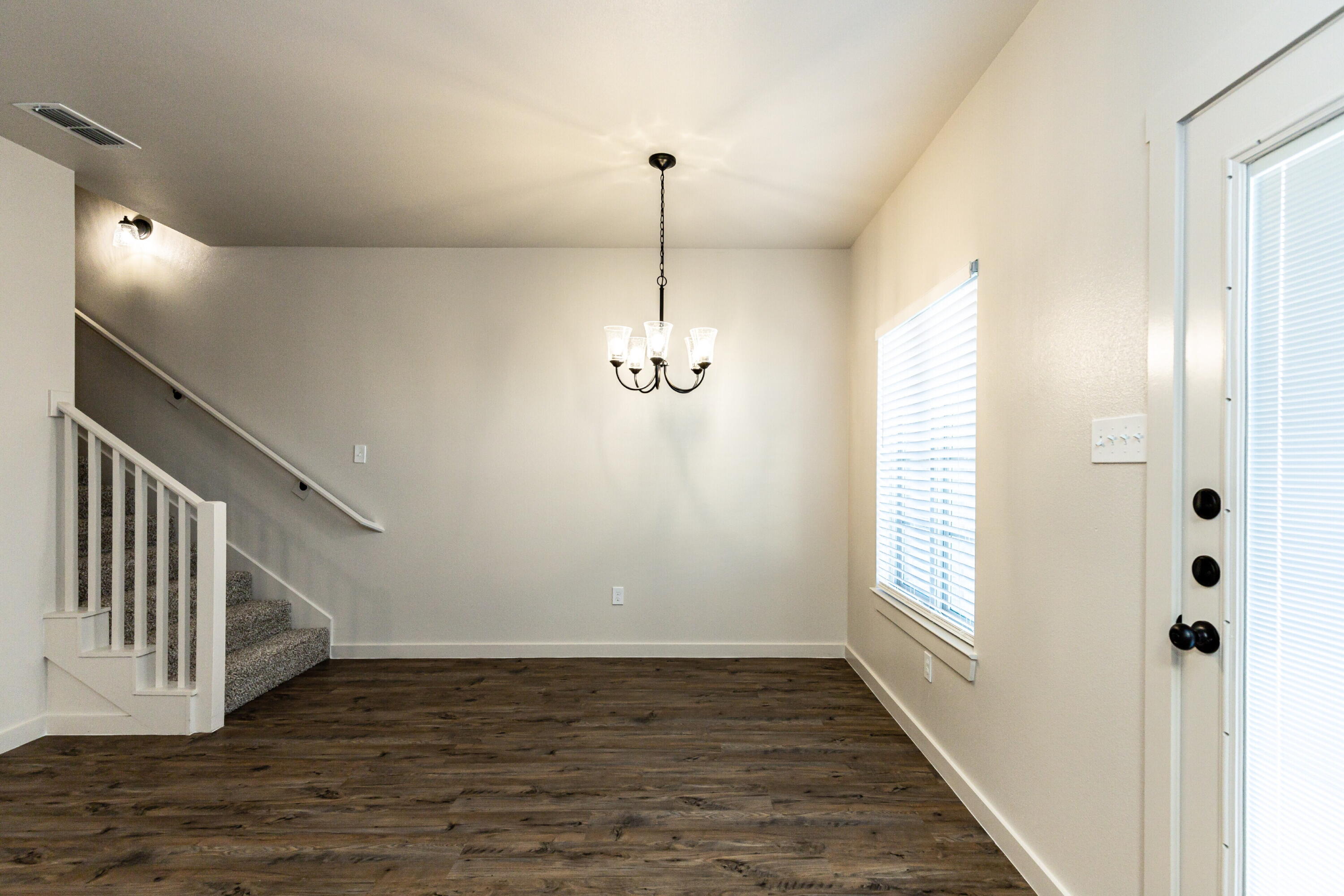 2526 138th Street Lubbock, TX 79423 - Photo 19 of 36 a view of a hallway with wooden floor and staircase