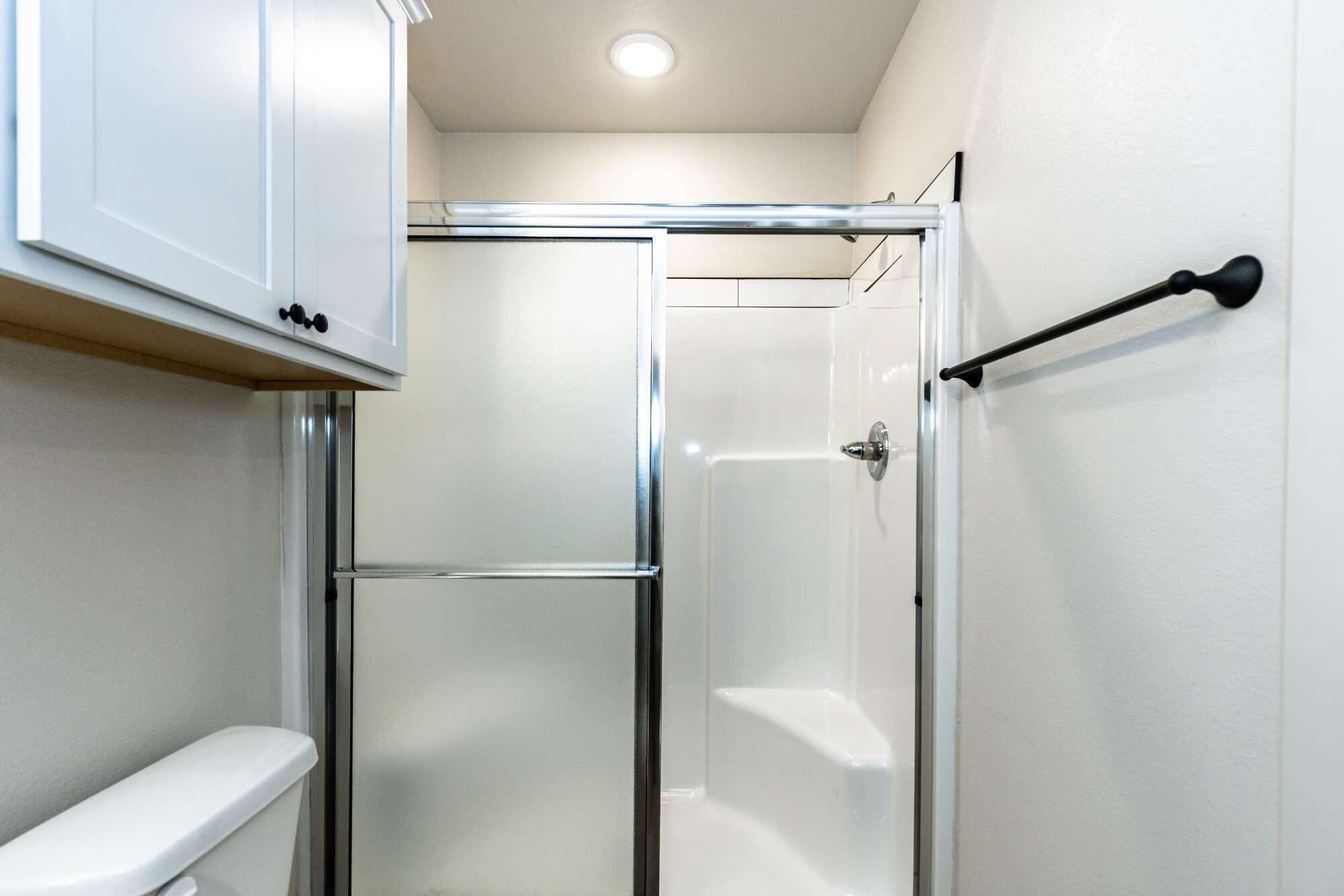 2526 138th Street Lubbock, TX 79423 - Photo 27 of 36 a bathroom with a glass shower door