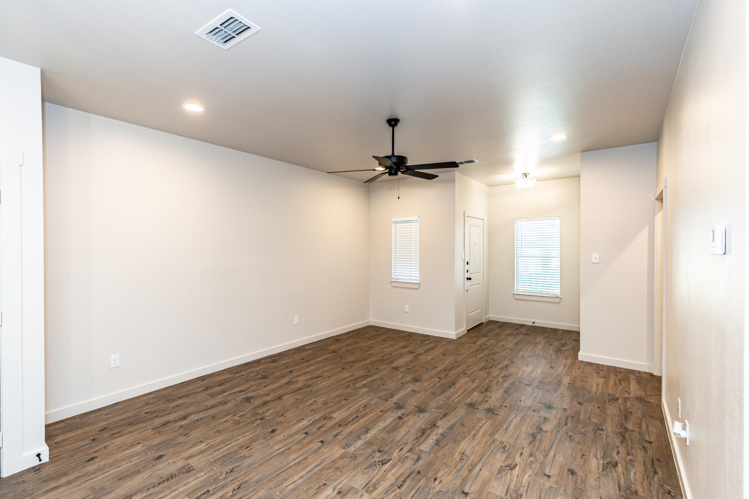 2526 138th Street Lubbock, TX 79423 - Photo 10 of 36 an empty room with wooden floor a ceiling fan and closet