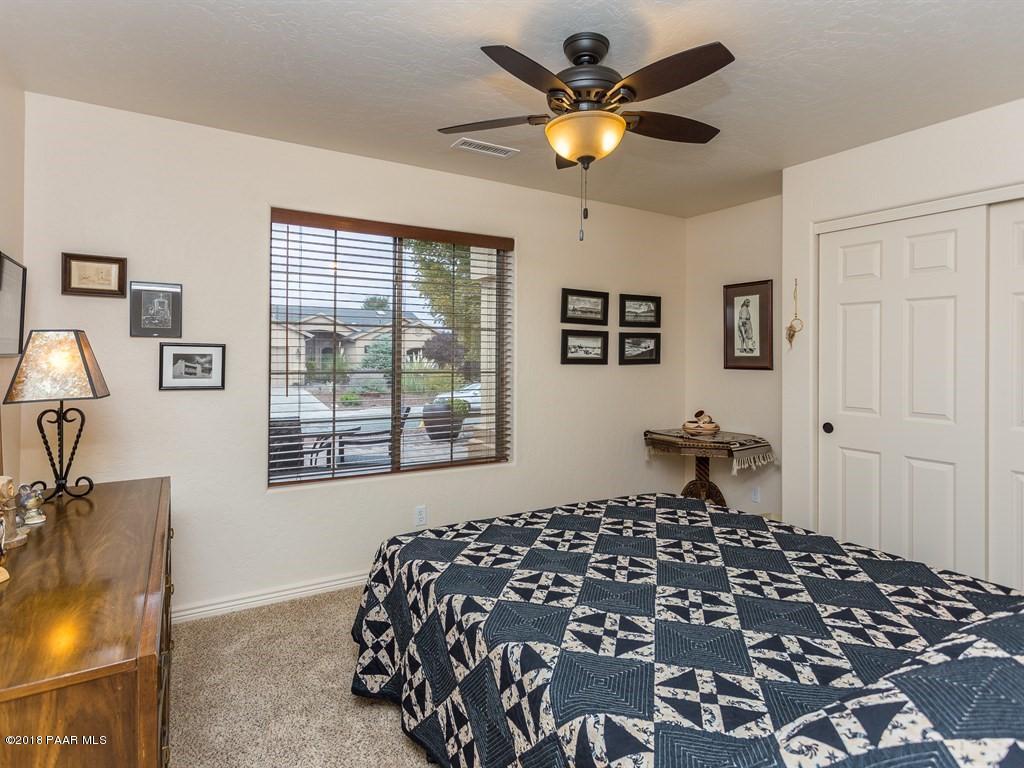 7969 North Sunset Ridge Prescott Valley, AZ 86315 - Photo 12 of 19 a bedroom with a bed and wooden floor