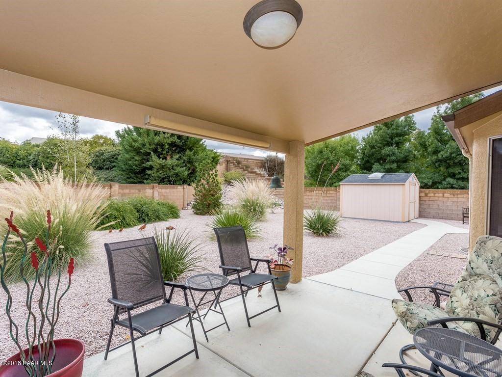 7969 North Sunset Ridge Prescott Valley, AZ 86315 - Photo 16 of 19 a view of a chairs and table in patio