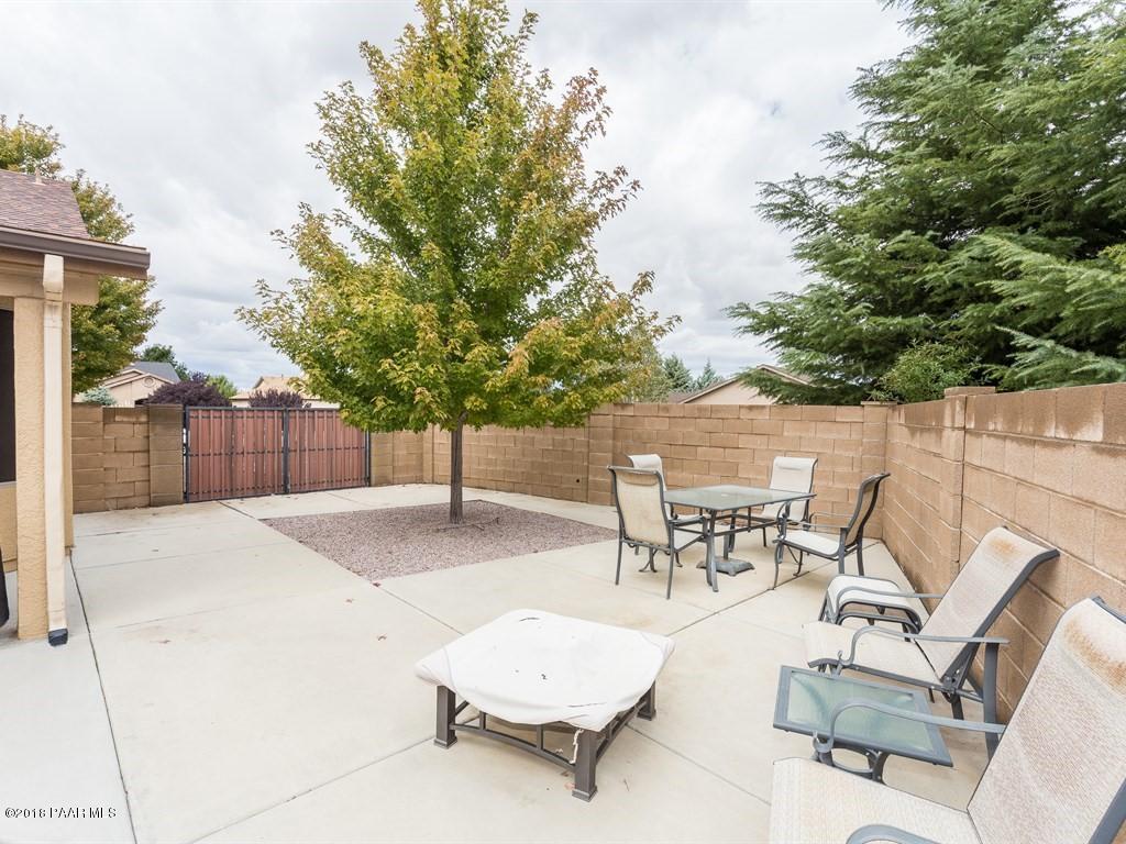 7969 North Sunset Ridge Prescott Valley, AZ 86315 - Photo 19 of 19 a view of a patio with a table and chairs