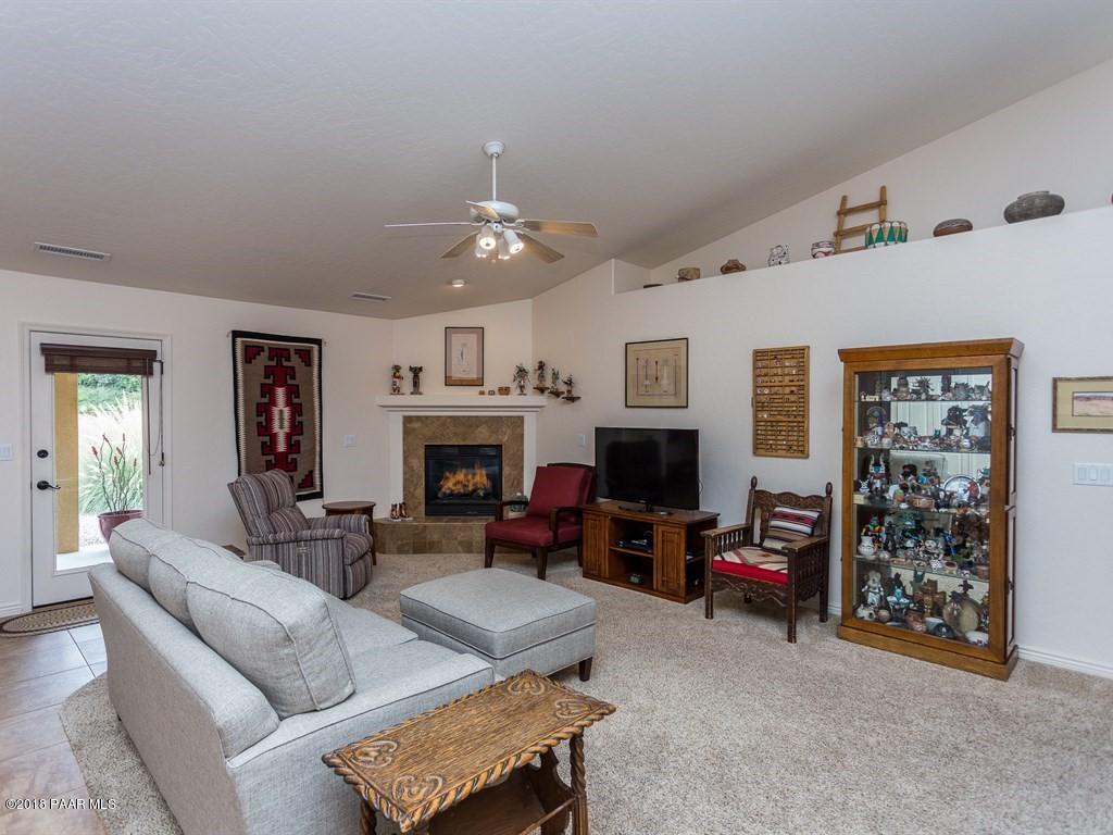 7969 North Sunset Ridge Prescott Valley, AZ 86315 - Photo 3 of 19 a living room with furniture and a fireplace