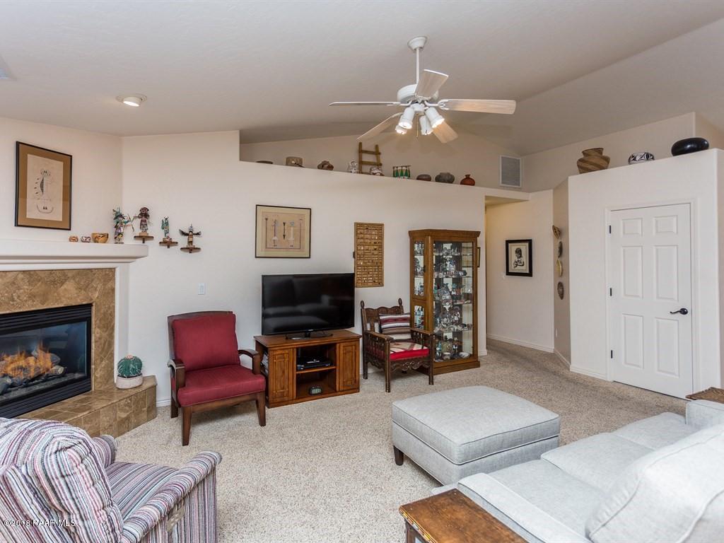 7969 North Sunset Ridge Prescott Valley, AZ 86315 - Photo 4 of 19 a living room with furniture and a fireplace