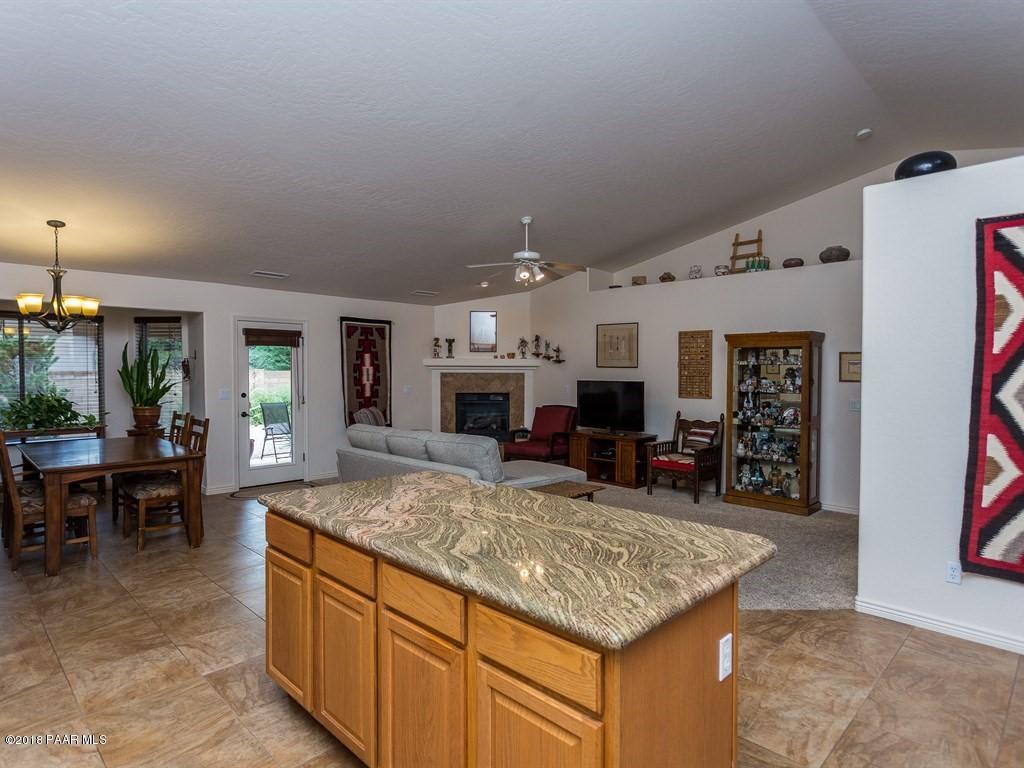 7969 North Sunset Ridge Prescott Valley, AZ 86315 - Photo 6 of 19 a kitchen with kitchen island counter top space and stainless steel appliances