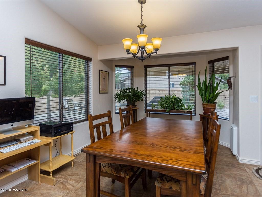 7969 North Sunset Ridge Prescott Valley, AZ 86315 - Photo 8 of 19 a view of a dining room with furniture window and wooden floor