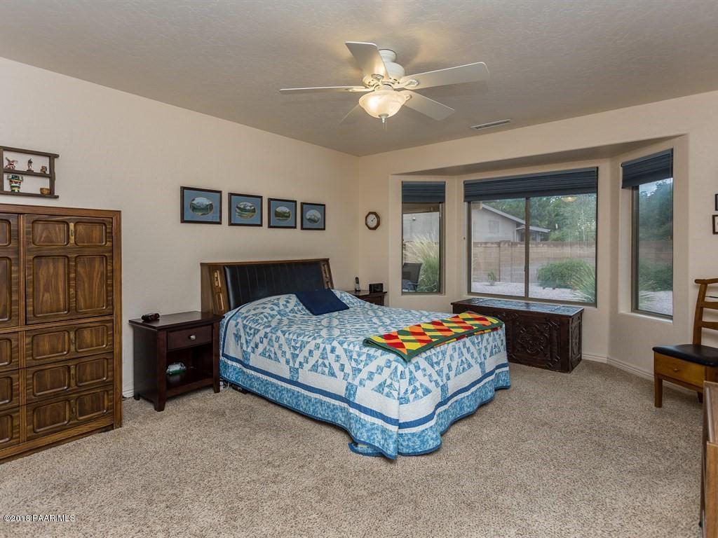 7969 North Sunset Ridge Prescott Valley, AZ 86315 - Photo 9 of 19 a bedroom with a bed and a large window