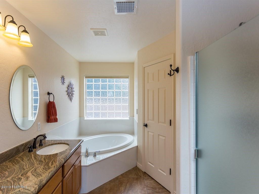 7969 North Sunset Ridge Prescott Valley, AZ 86315 - Photo 10 of 19 a bathroom with a tub sink and mirror