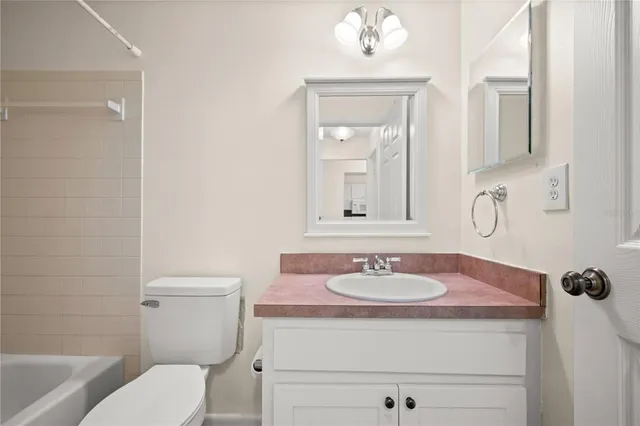 a bathroom with a sink toilet and mirror