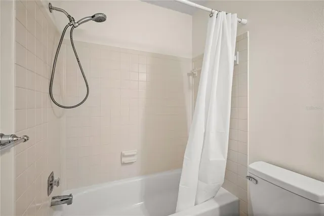 a bathroom with a bath tub with a shower