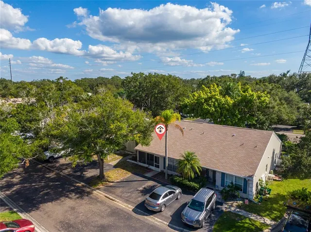 an aerial view of residential houses with outdoor space and street view