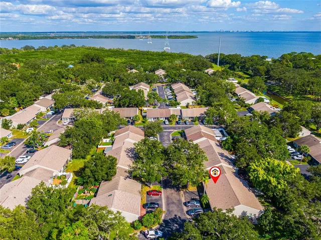 an aerial view of residential houses with outdoor space and trees