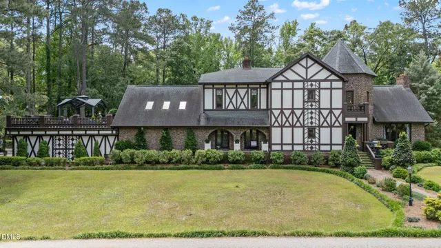 an aerial view of a house with outdoor space swimming pool and tennis court