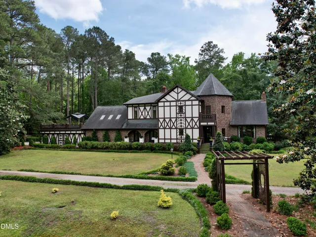 an aerial view of a house with balcony and garden