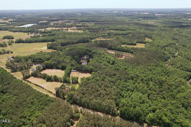 an aerial view of a houses with a yard