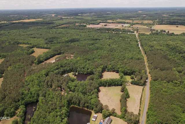 a backyard of a house with yard and outdoor seating