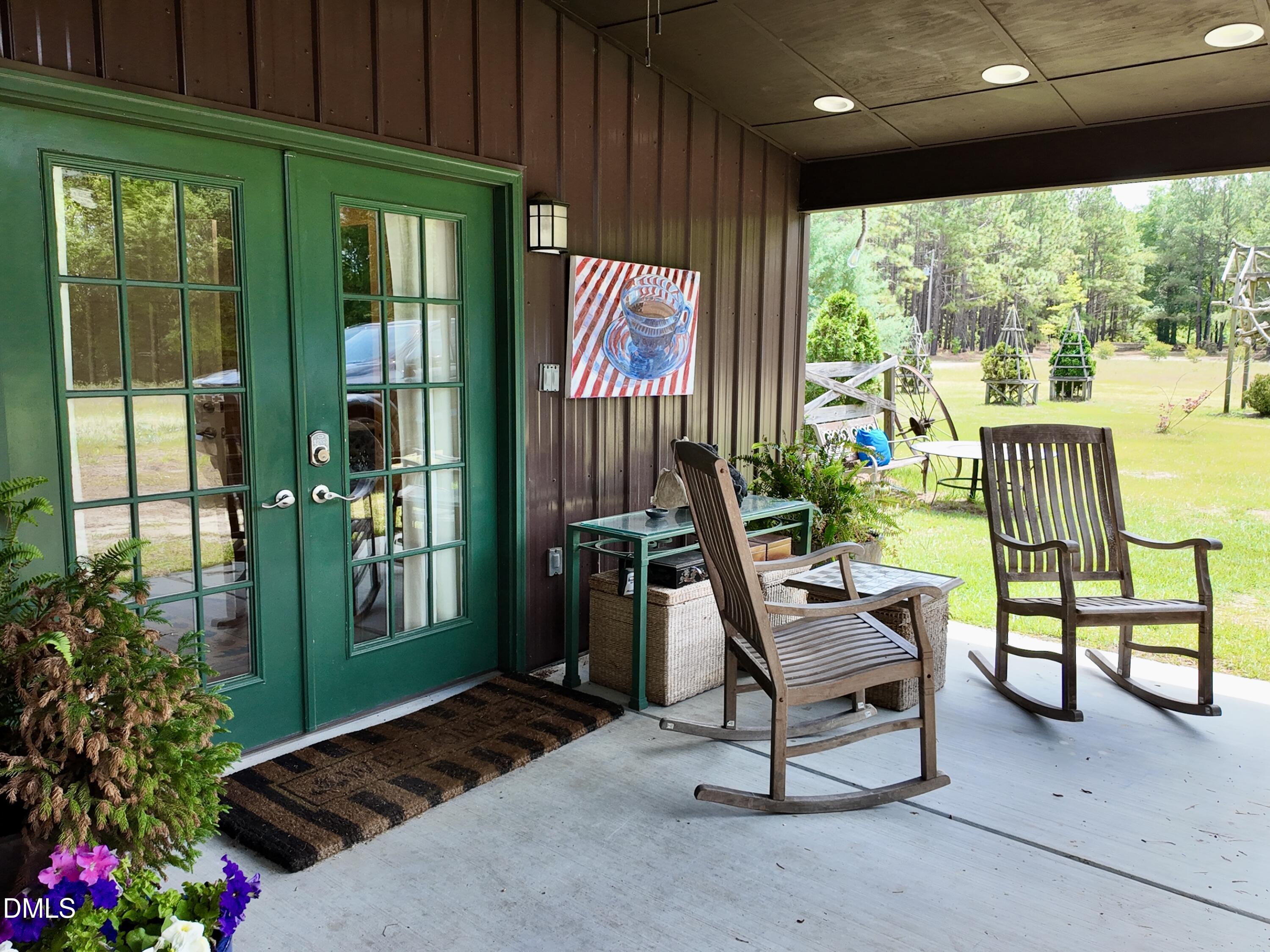 768 Bethesda Church Road Orrum, NC 28369 - Photo 33 of 91 a building outdoor space with patio furniture and potted plants