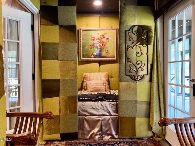 a view of a white house with a yard and outdoor seating