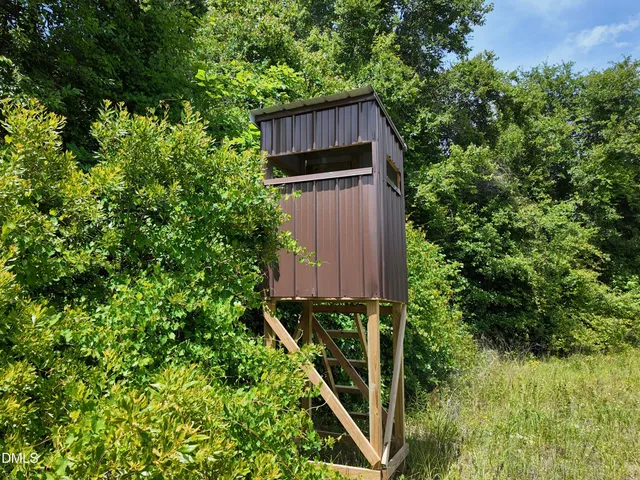 a front view of a house with a yard table and chairs