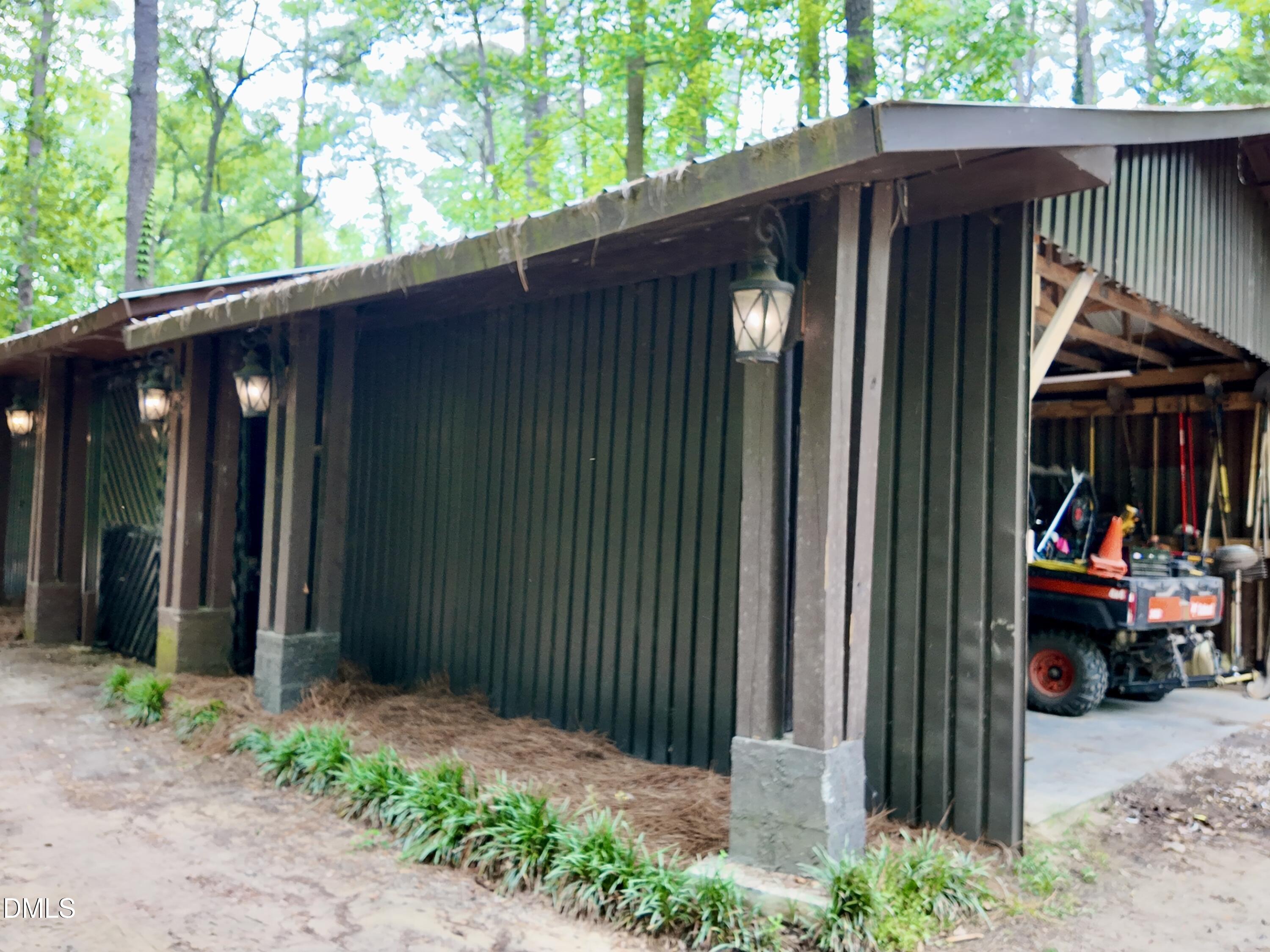 768 Bethesda Church Road Orrum, NC 28369 - Photo 61 of 91 a view of a wooden house with a small yard and large trees