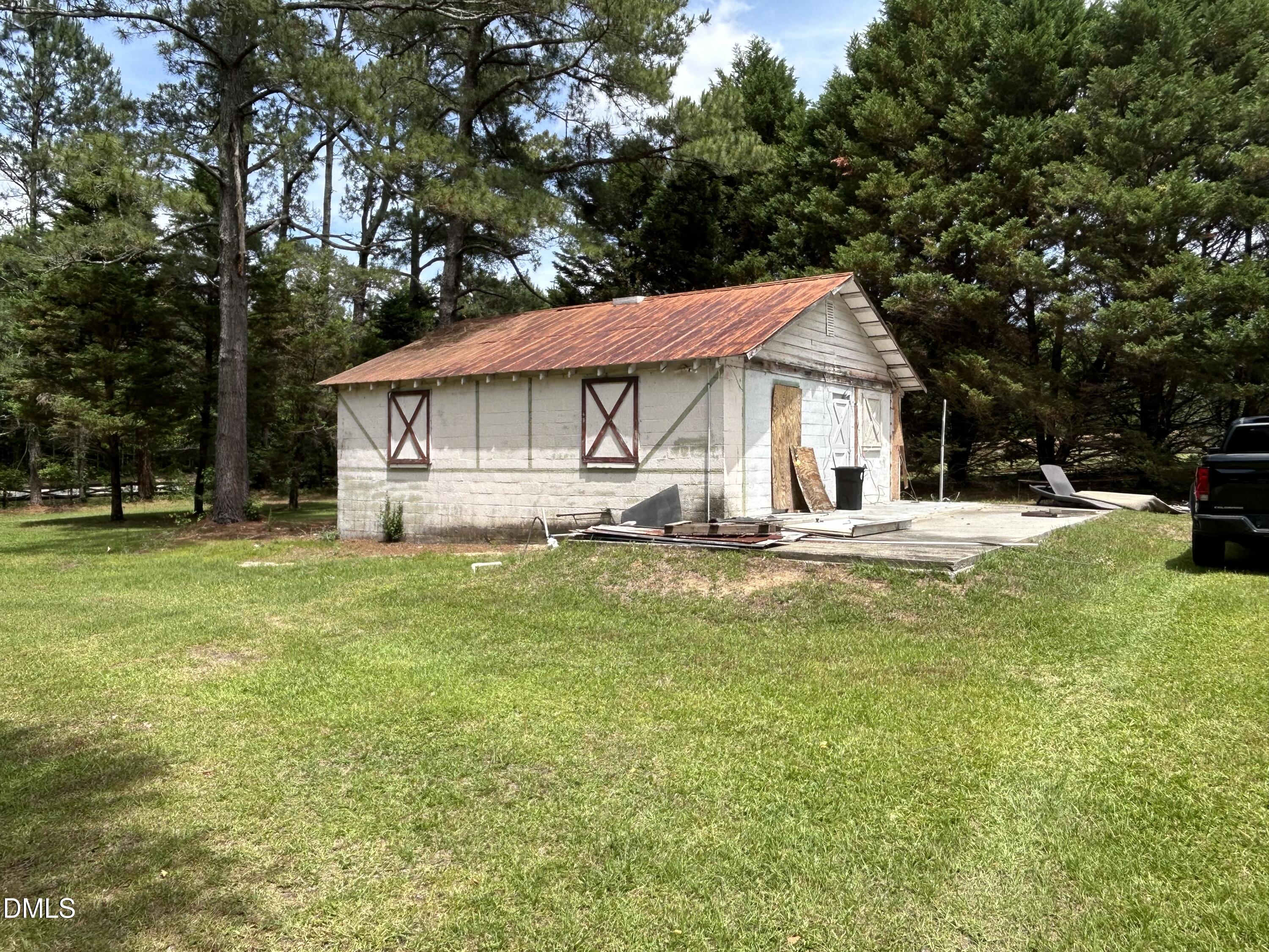 768 Bethesda Church Road Orrum, NC 28369 - Photo 81 of 91 a front view of a house with a yard table and chairs