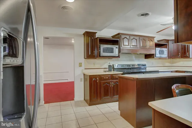 a kitchen with stainless steel appliances granite countertop a stove and a microwave