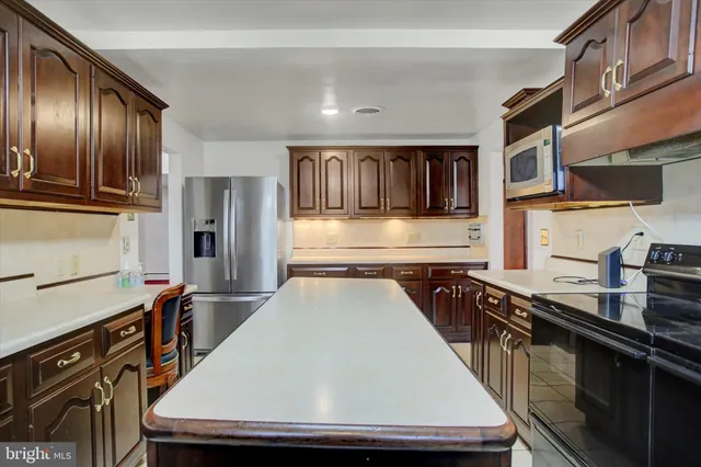 a kitchen with stainless steel appliances granite countertop a sink and refrigerator