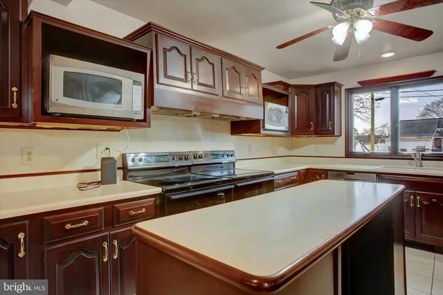 a kitchen with a stove a sink and a microwave