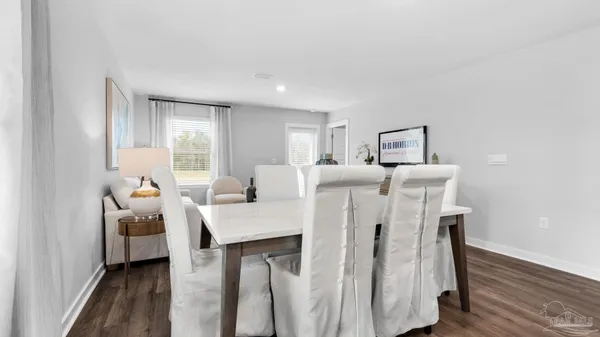 a view of a kitchen with furniture and wooden floor