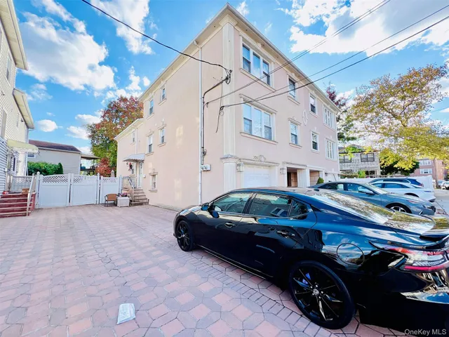 a car parked in front of white building