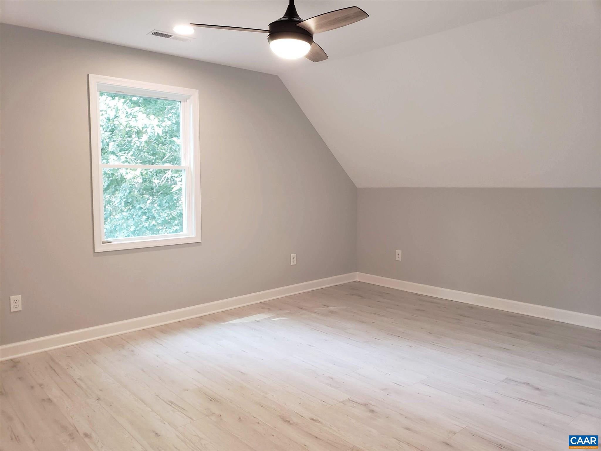 699 Black Cat Road Keswick, VA 22947 - Photo 21 of 33 en empty room with windows and ceiling fan
