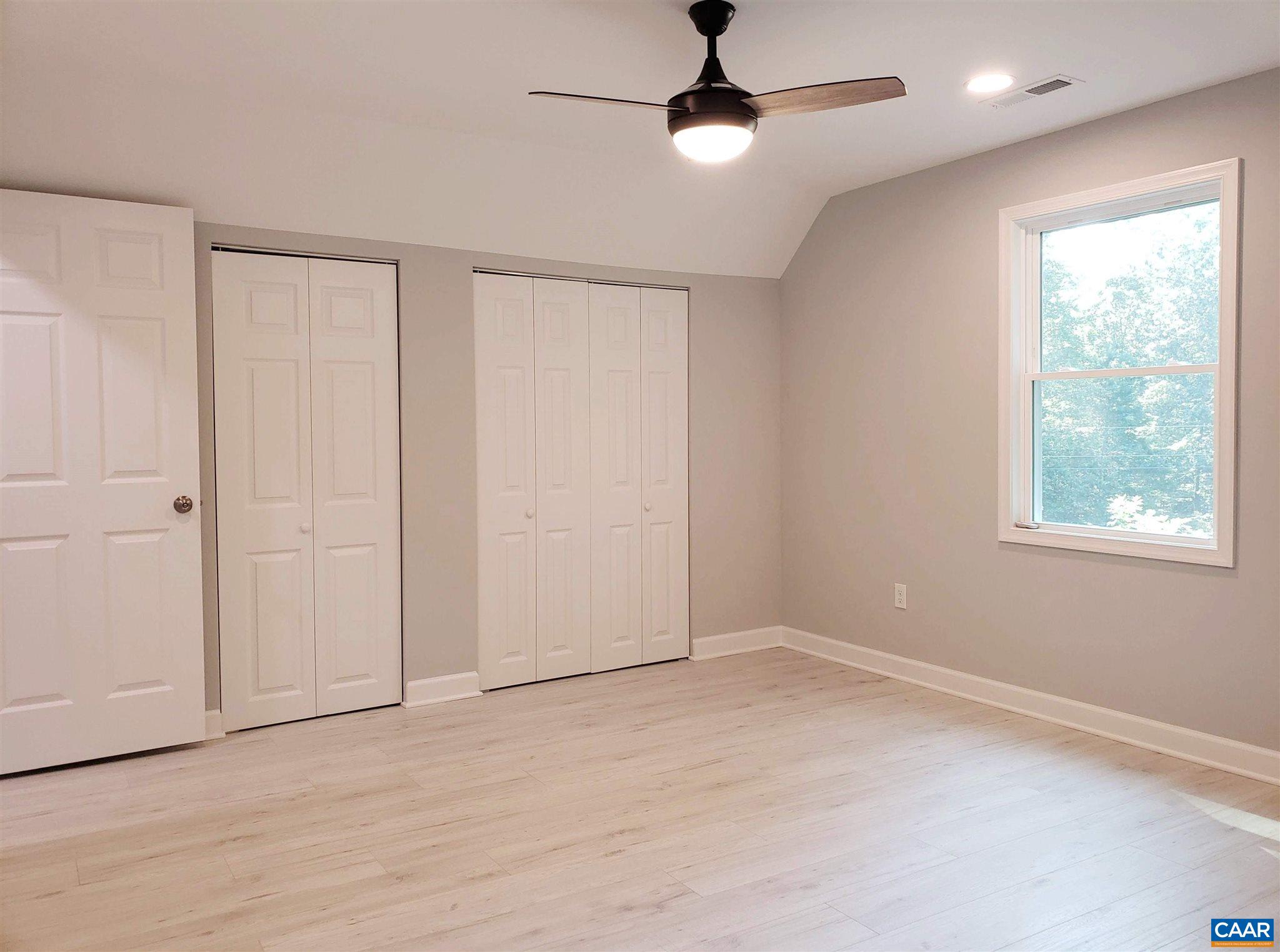 699 Black Cat Road Keswick, VA 22947 - Photo 22 of 33 a view of an empty room with a window